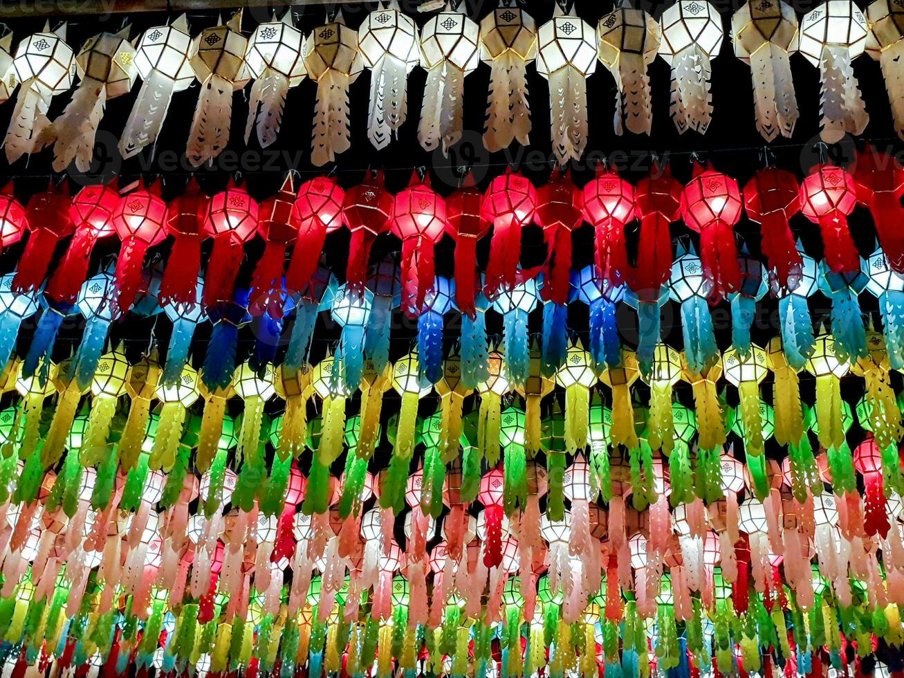 Colorful look up view of Thai Lanna style lanterns to hang in front of the temple on night time in Loy Kratong Festival. photo