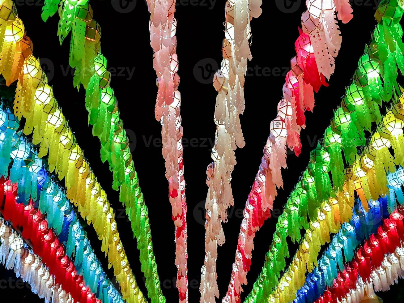 Colorful perspective and look up view of Thai Lanna style lanterns to hang in front of the temple on night time in Loy Kratong Festival. photo