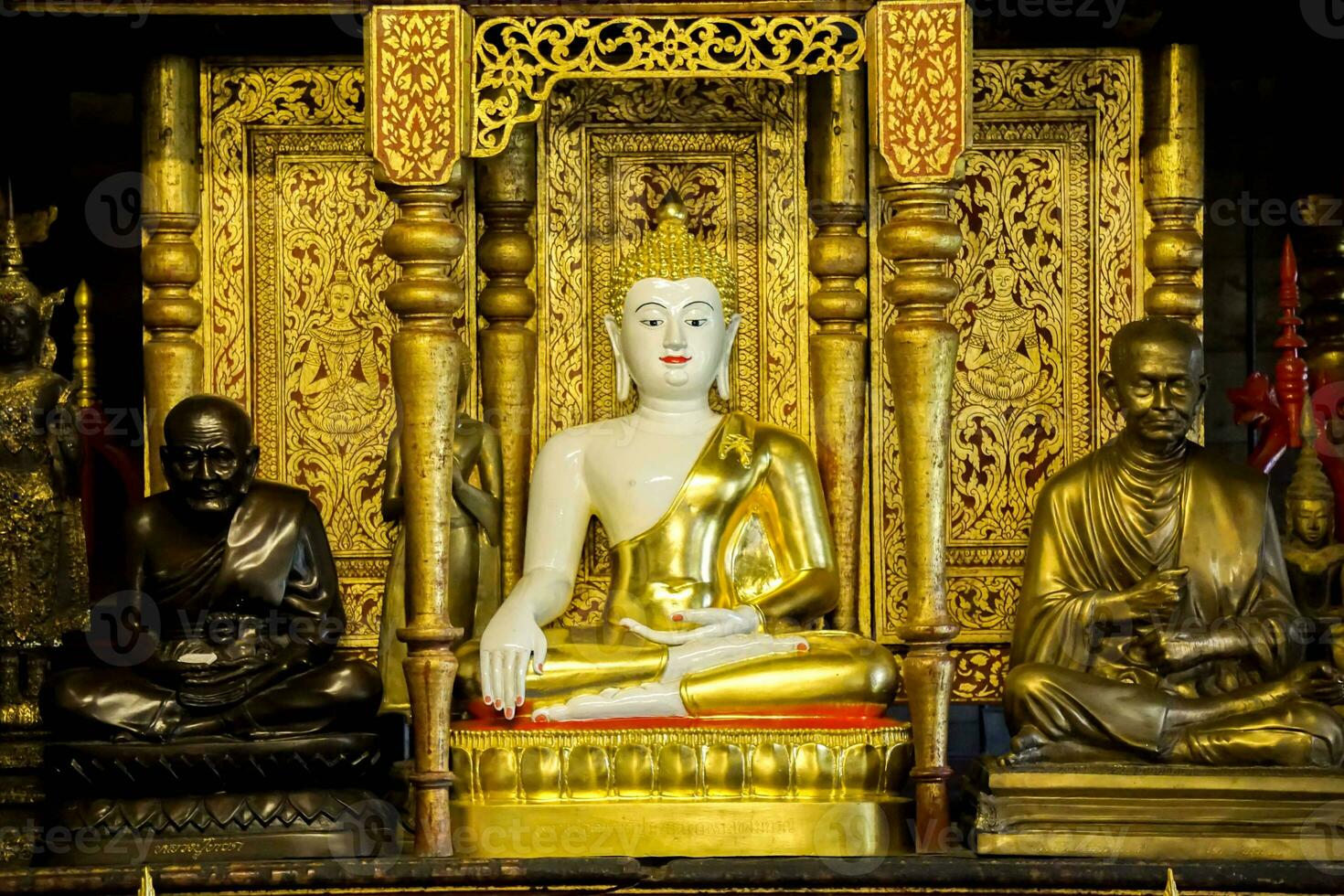 Ancient golden Buddha statue of Burmese art in sanctuary at Wat Phra That Hariphunchai Lumphun Thialand. photo