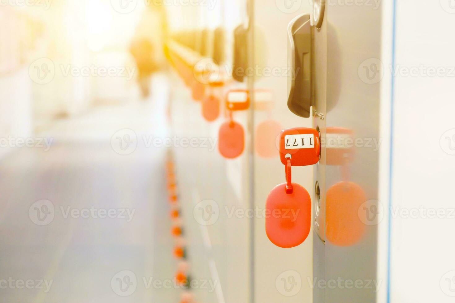 Closeup key of coins locker with sun flare on blurry background. photo