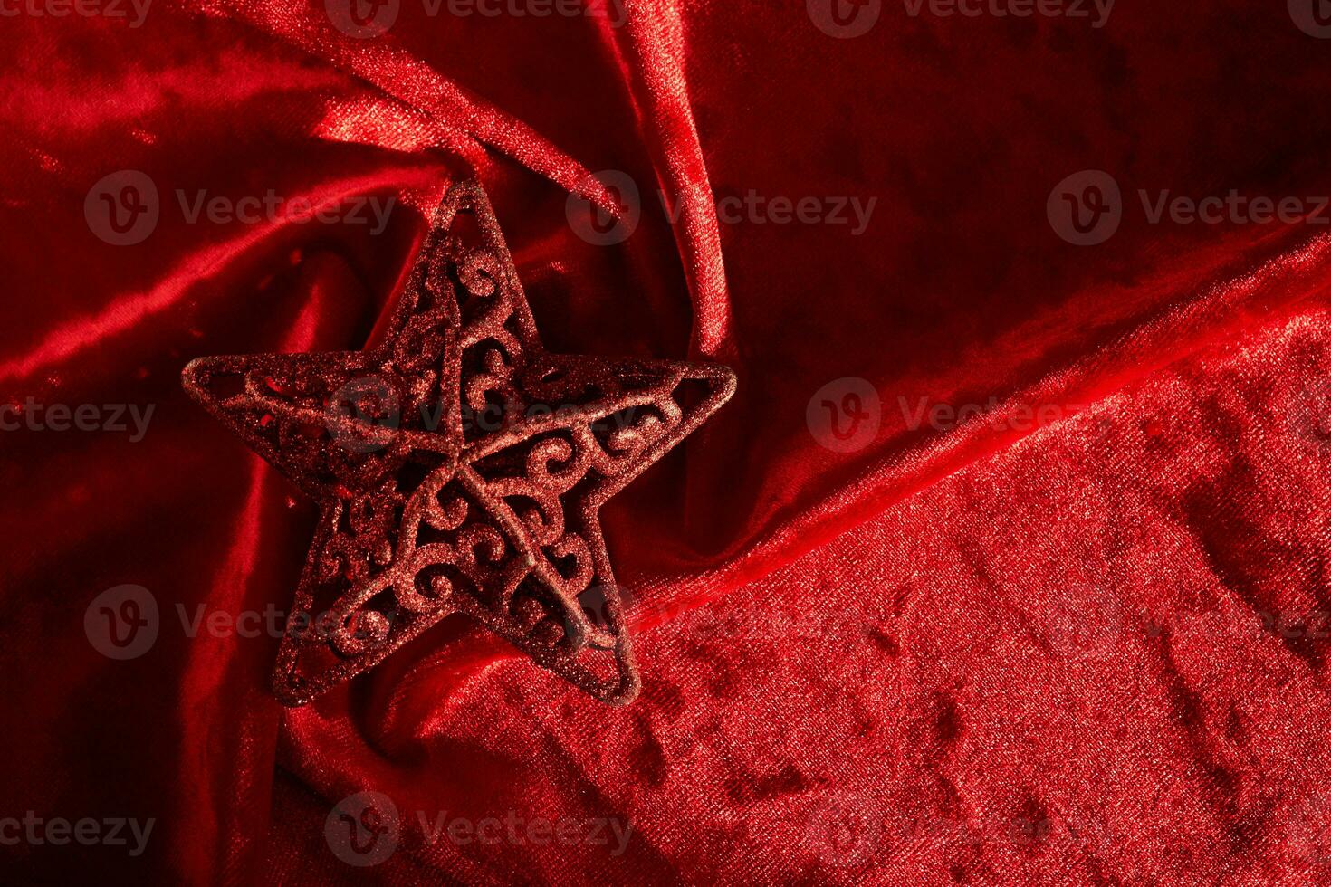 Abstract Christmas background with star on a red velvet background. photo