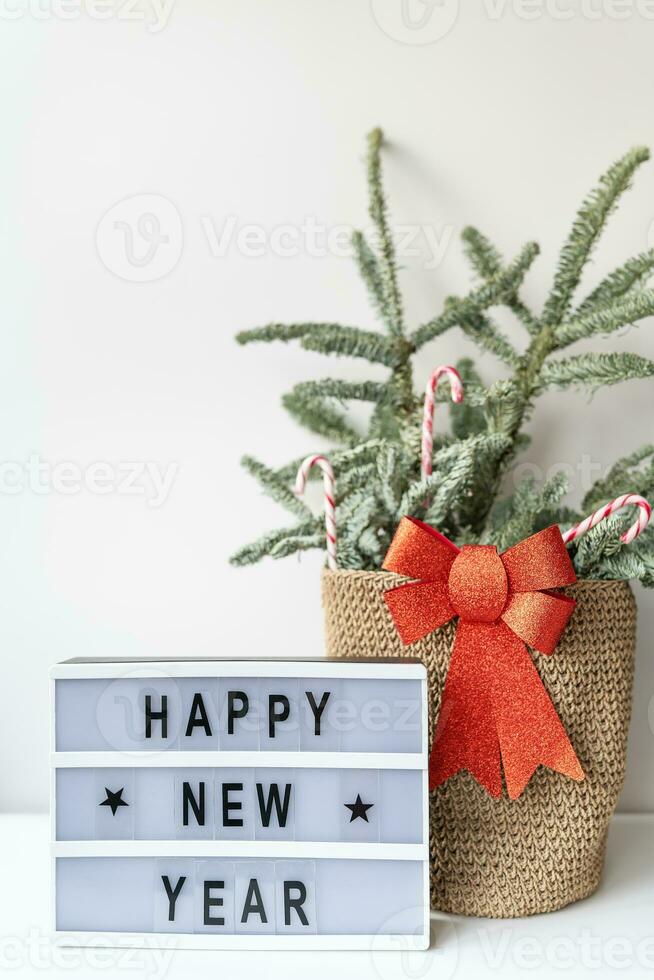 Happy New Year on vintage lightbox with New Years Eve decoration, concept image. Nobilis in a basket of candies. photo