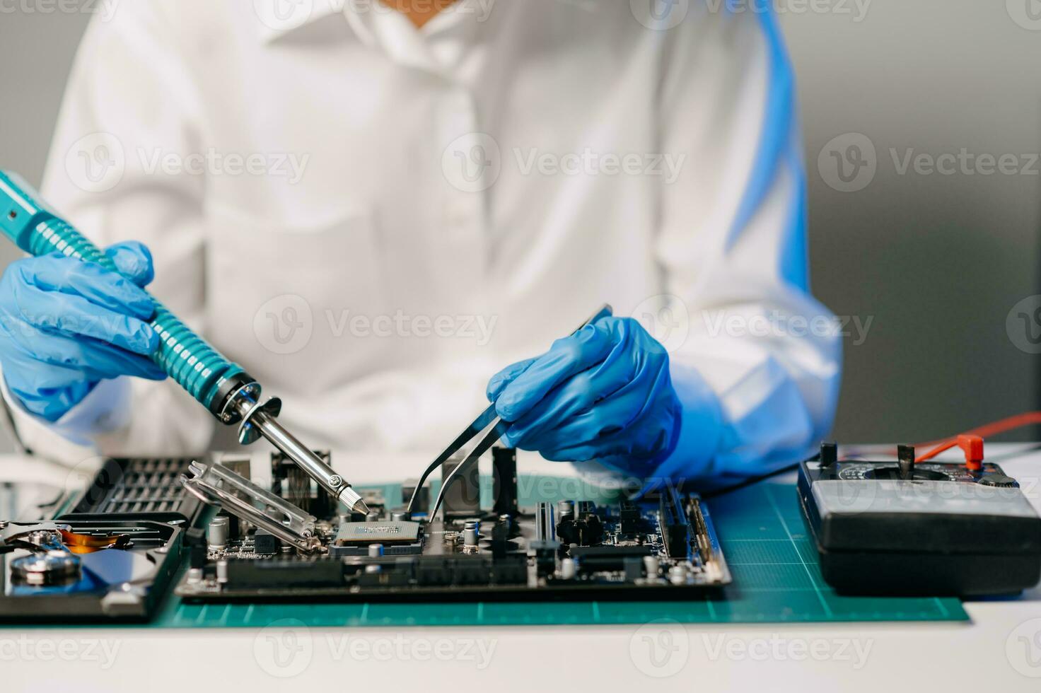The technician is putting the CPU on the socket of the computer motherboard. electronic engineering electronic repair, electronics measuring and testing, repair photo