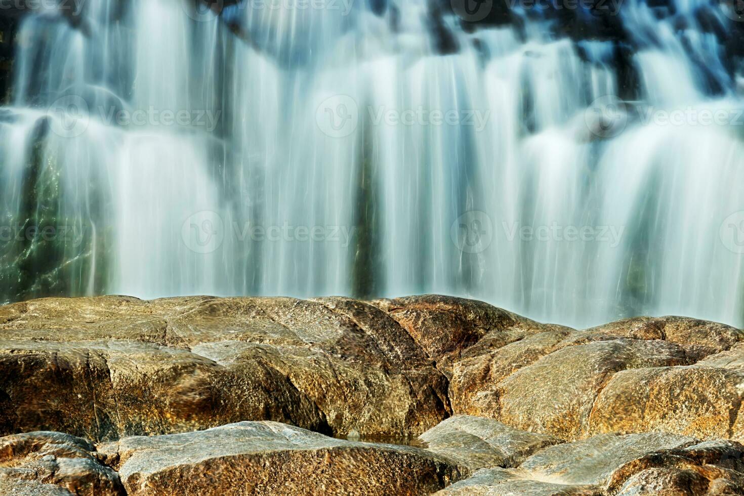 Small waterfall and stone with water motion. photo