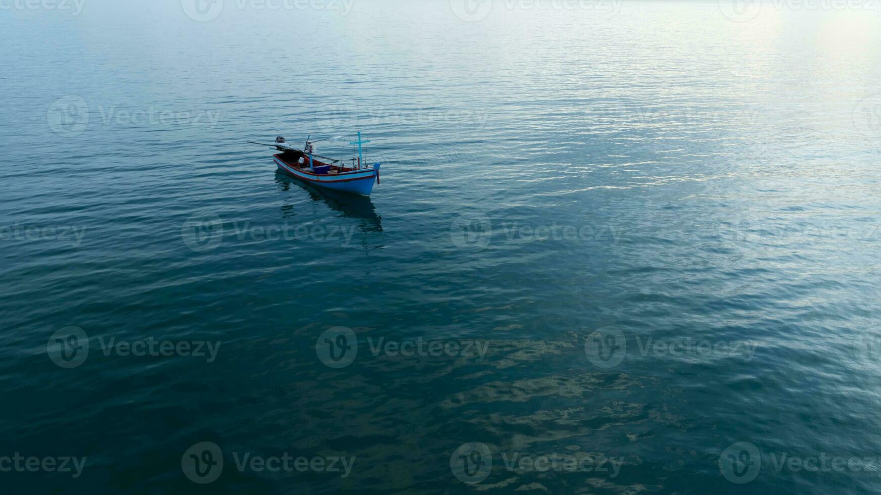 Minimal image of fishing boat on the sea. photo