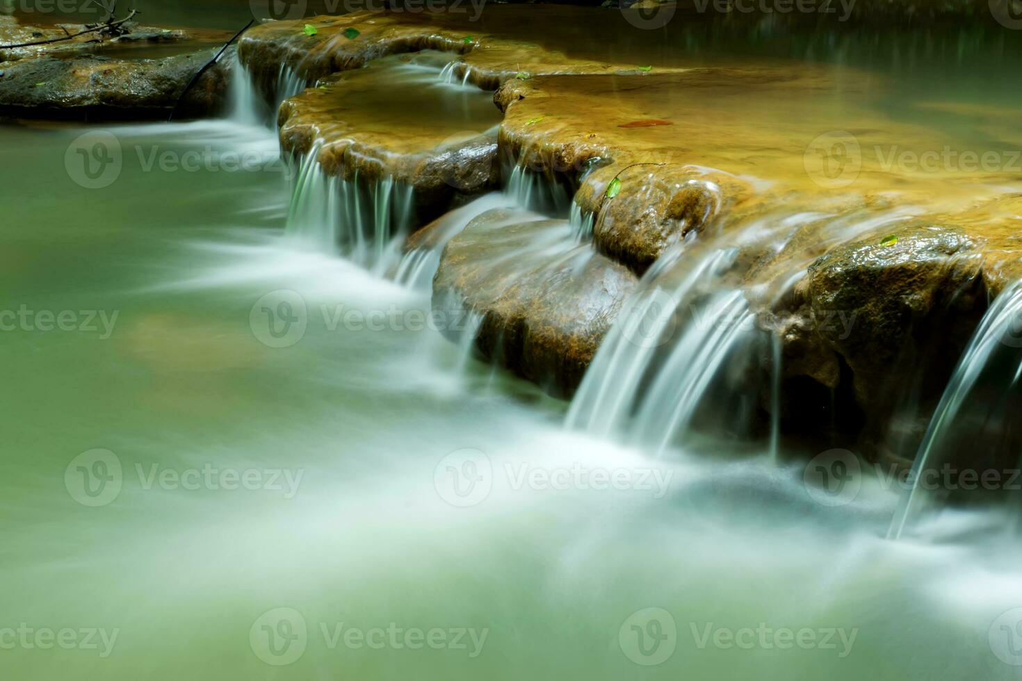 Small waterfall in the forest in summer. photo