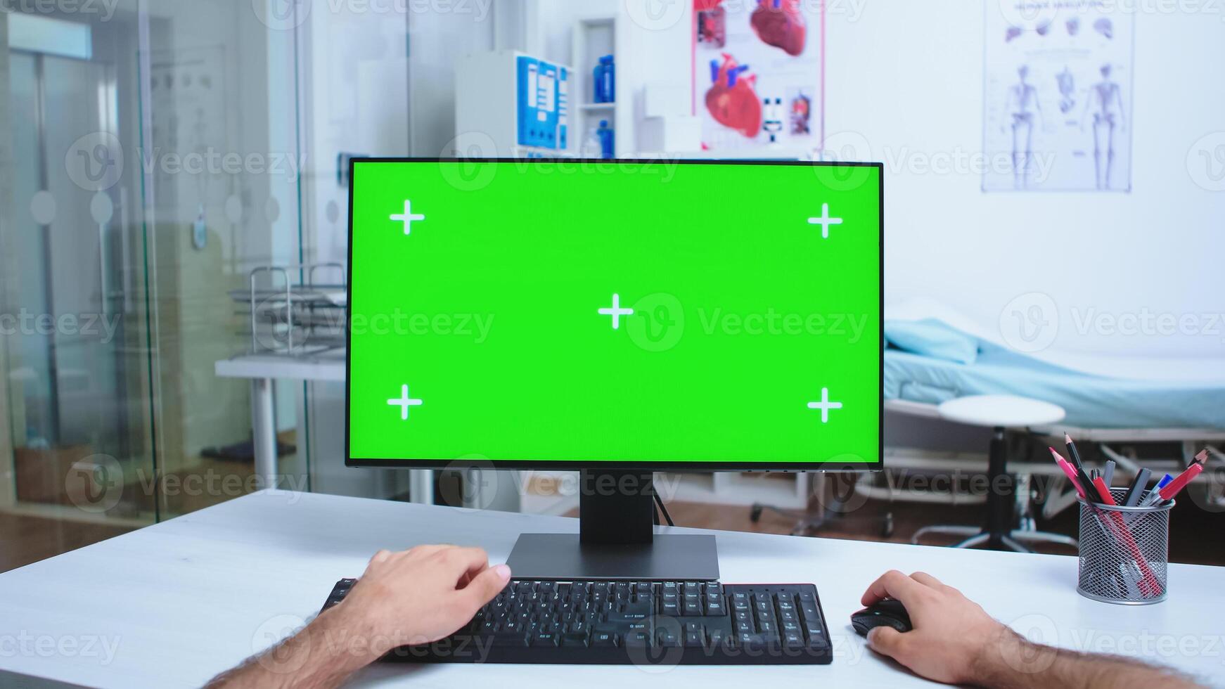 Pov of health physician working on computer with chroma key in hospital cabinet and doctor leaving the clinic office. Medical physician in clinic cabinet working desktop with copy space available. photo