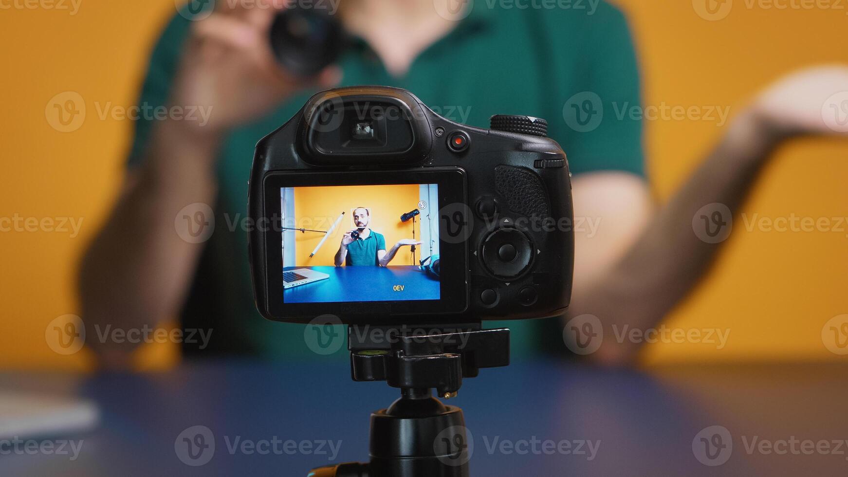 Artist testing camera lens while recording vlog episode in studio. Camera lens technology digital recording social media influencer content creator, professional studio for podcast, vlogging and blogging photo