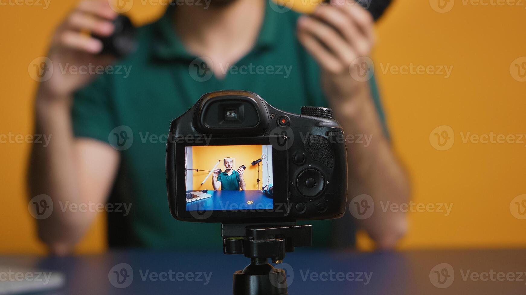 Content creator talking about camera lenses for online vlog. Camera lens technology digital recording social media influencer content creator, professional studio for podcast, vlogging and blogging photo