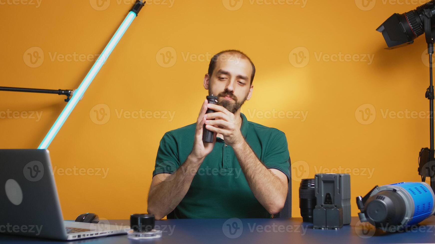 Content creator recording mini trepied review in studio. Testimonial of influencer. Professional studio video and photo equipment technology for work, photo studio social media star and influencer