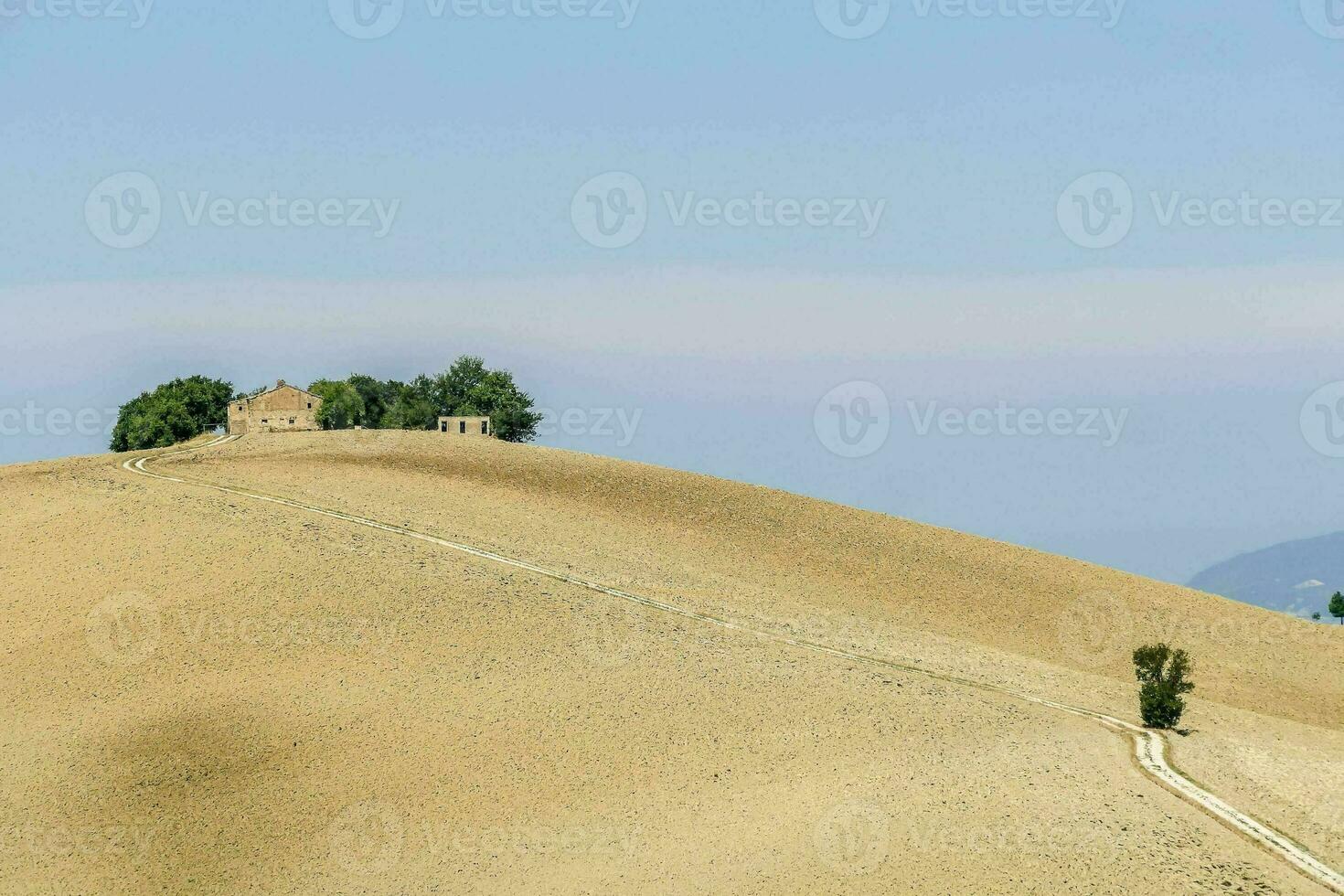 a road leads to a house on a hill photo