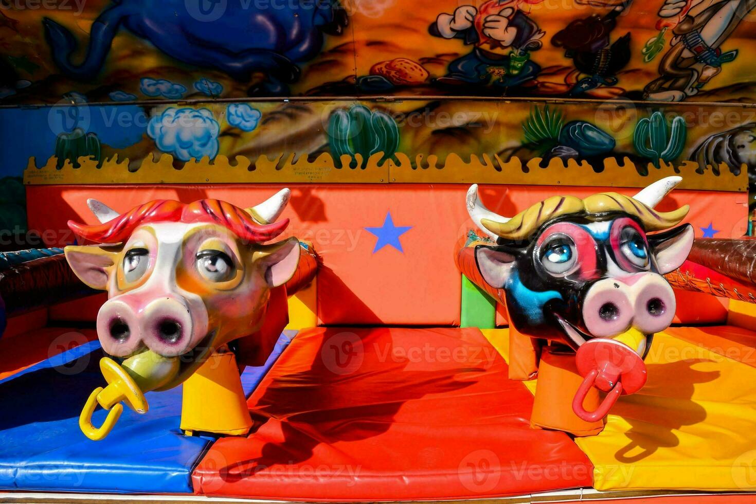 two cow heads on a carnival ride photo