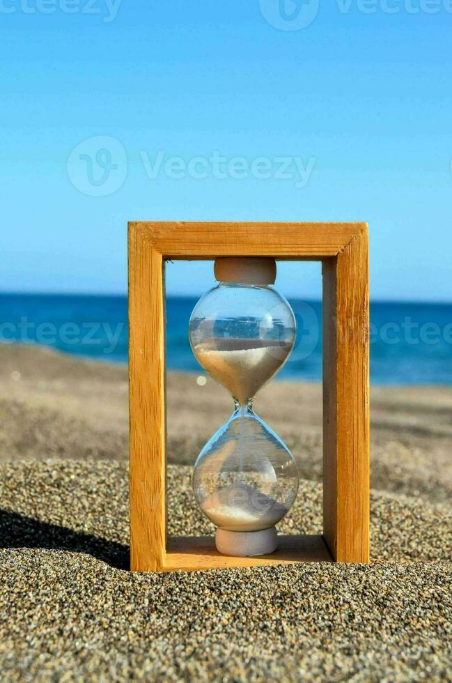 hourglass on the beach photo