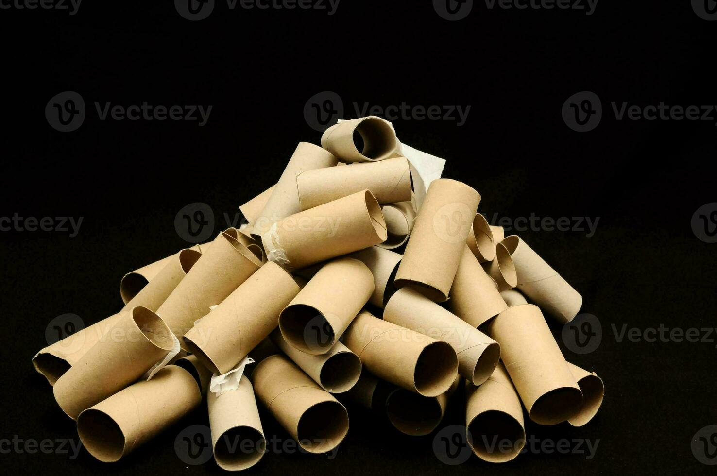 a pile of rolled up toilet paper tubes on a black background photo