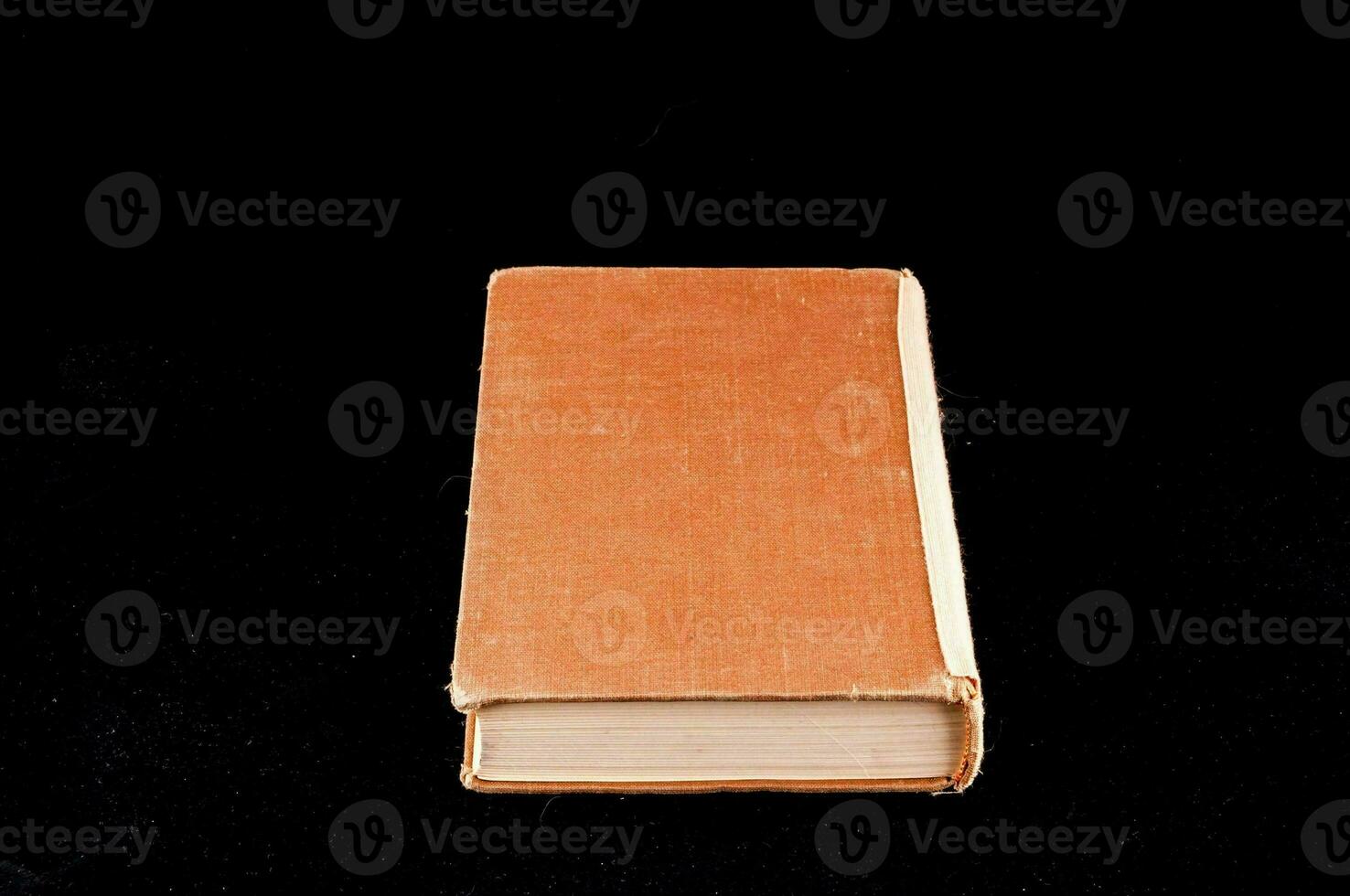 a closed book on a black background photo