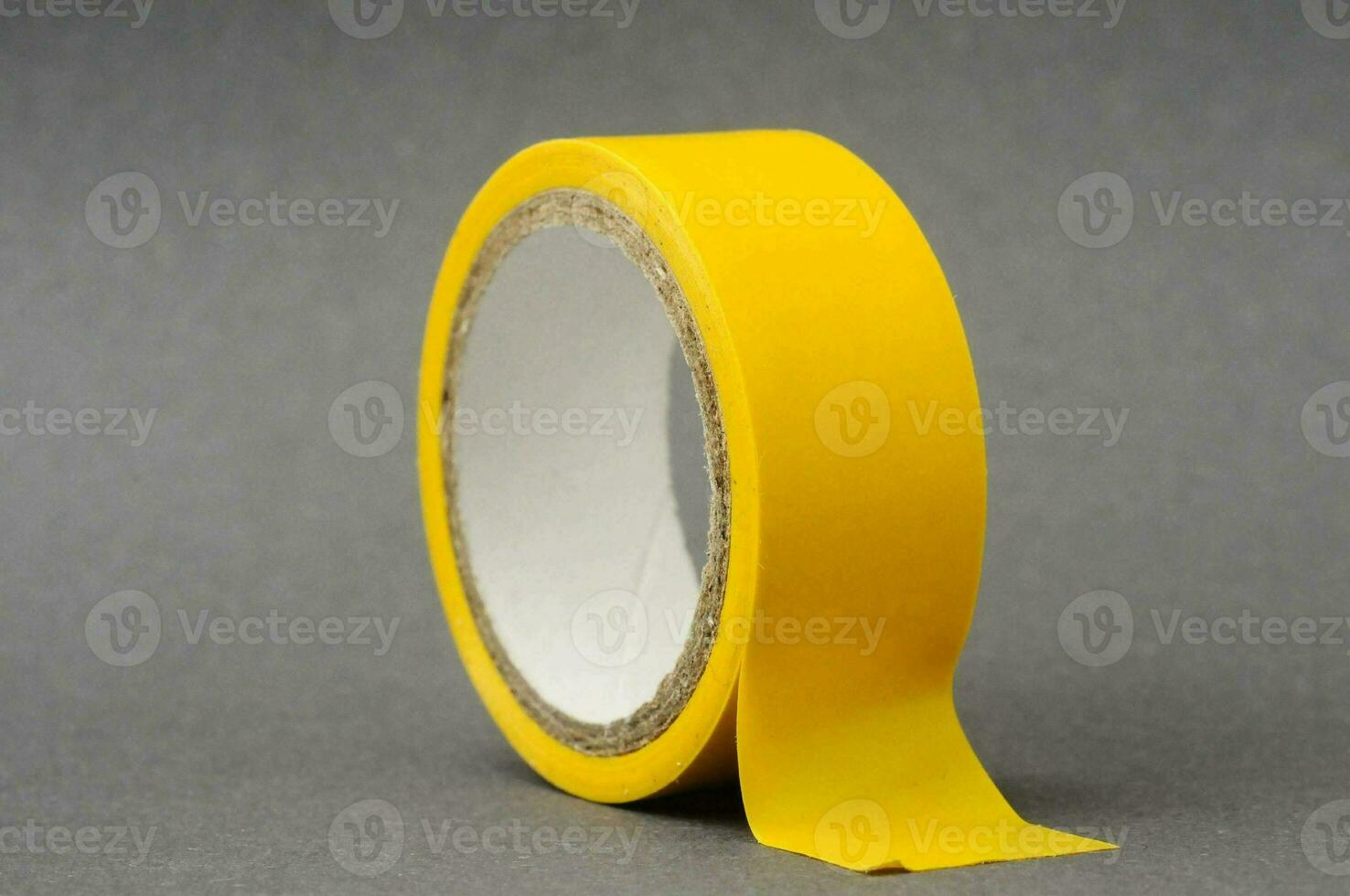 a yellow tape on a grey surface photo