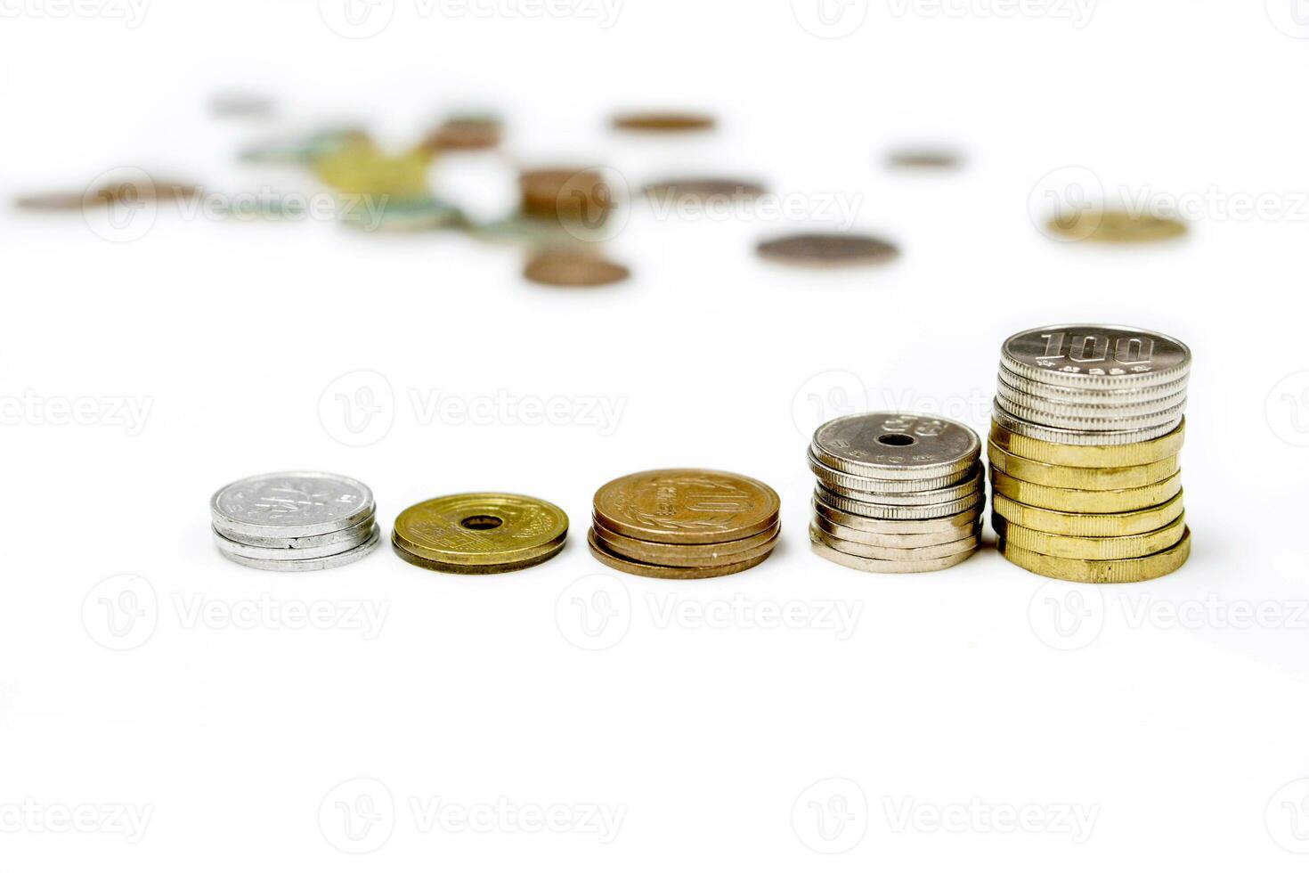 Side view and line up stacked of Japan Yen currency coins isolate on white and blurry  coins spread background. photo