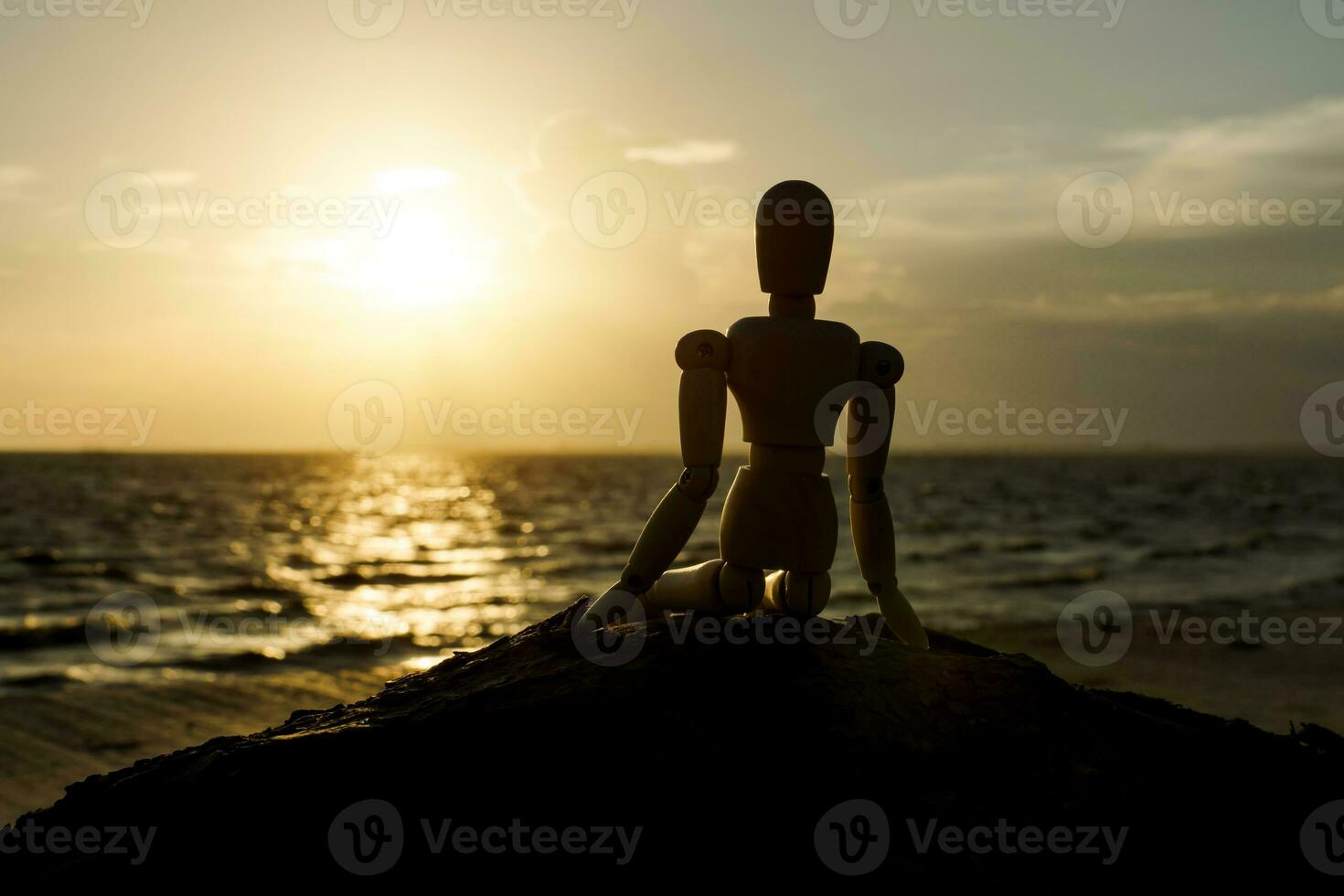 Silhouettes of wooden models feel lonely at sunset. photo