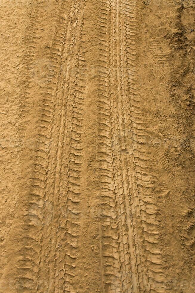 Wheel track on dry ground. photo