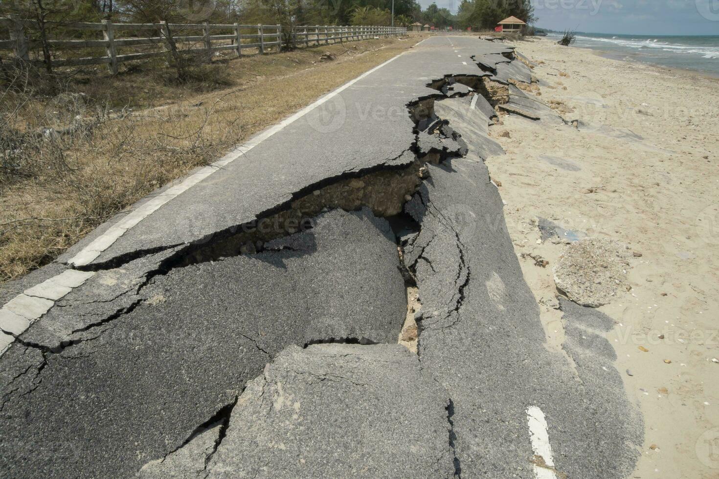 Road erosion caused by waves and severe storms. photo