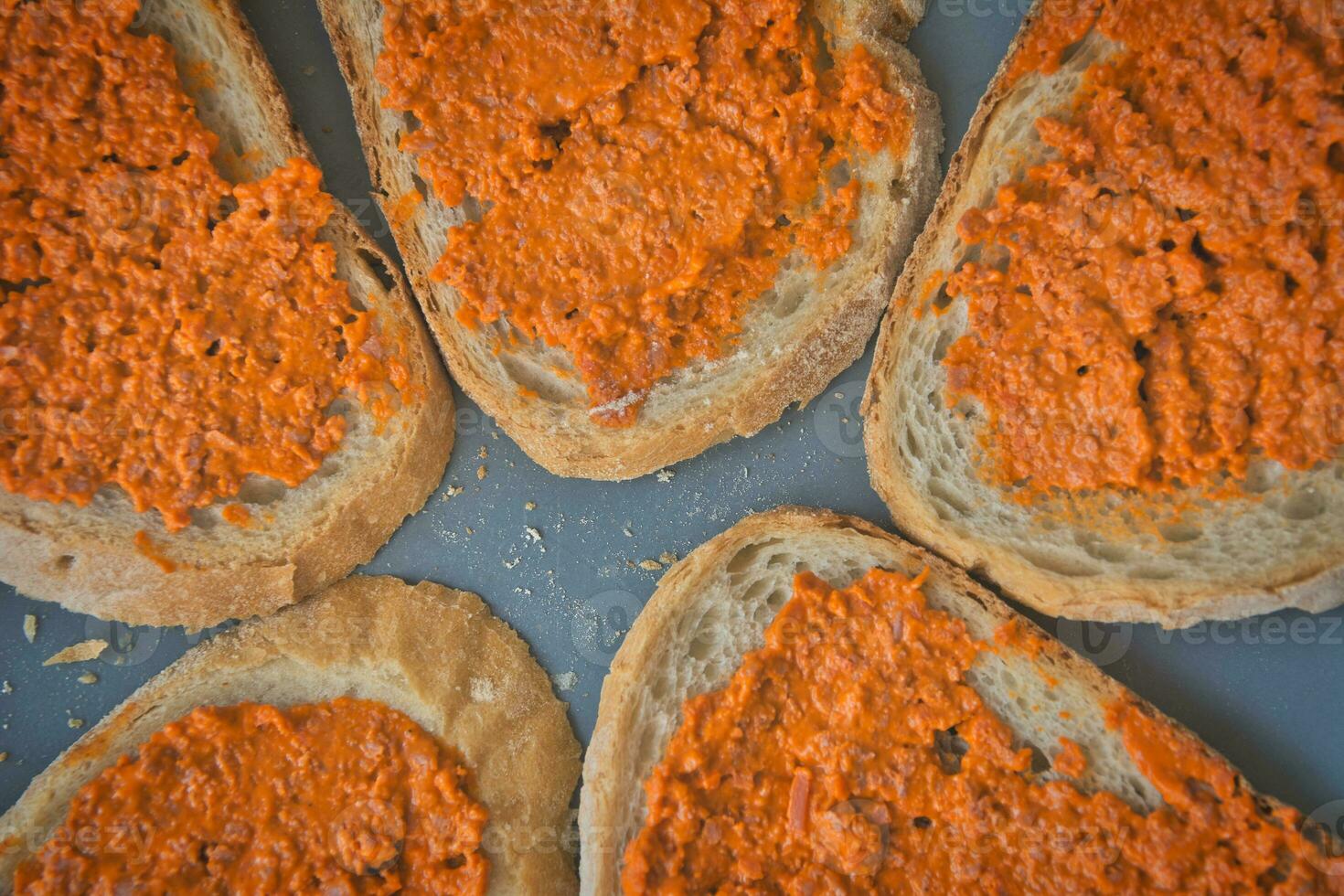 Directly above shot of slices of bread with vegan carrot spread. photo