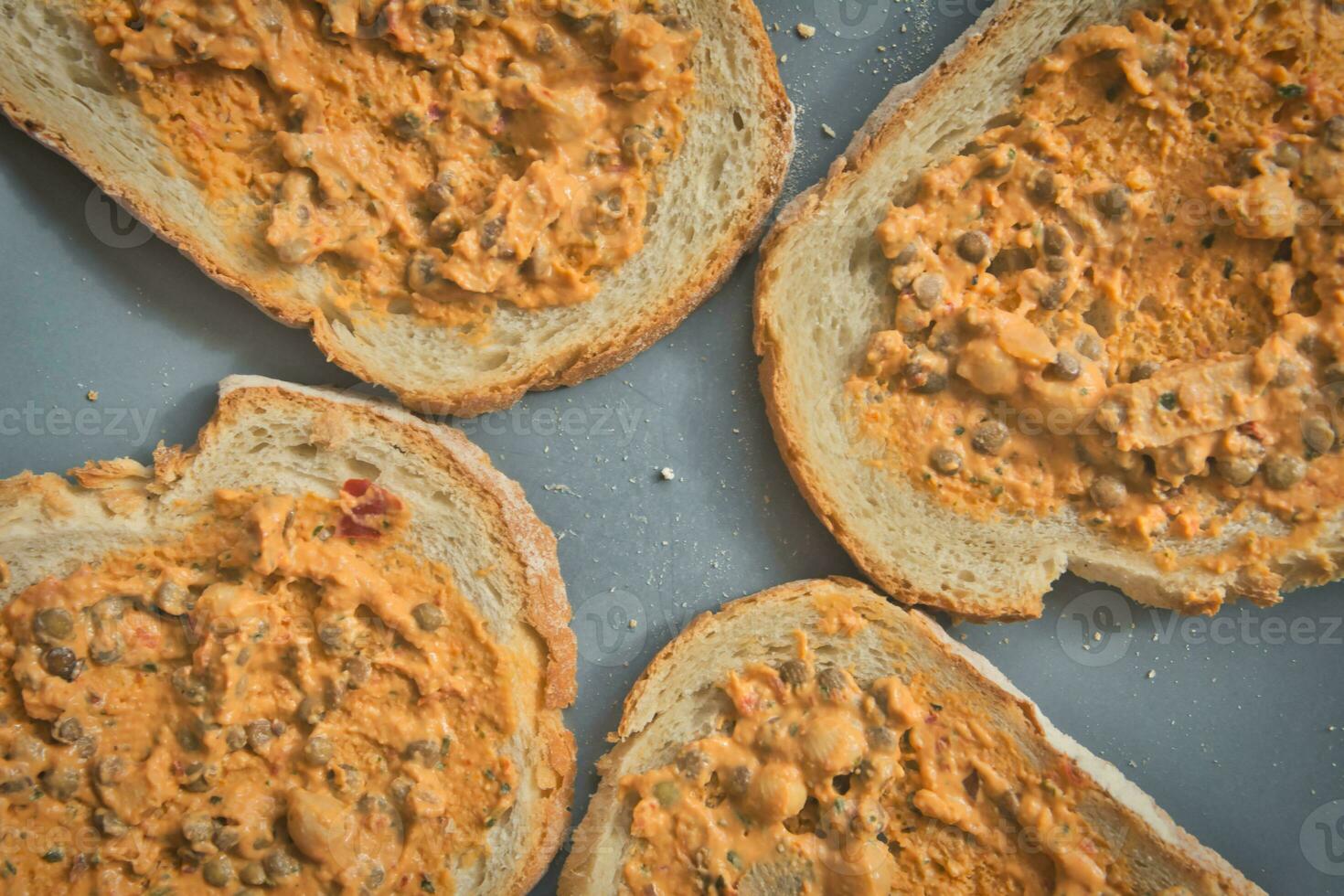 Plate of bread with lentil salad spread. photo