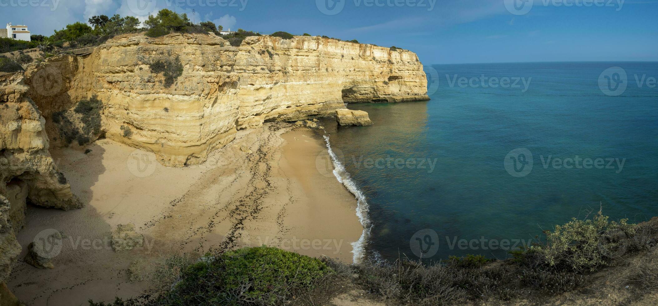 View on the empty beach of Praia do Pau in Lagoa on the coast of Algarve in Portugal. photo