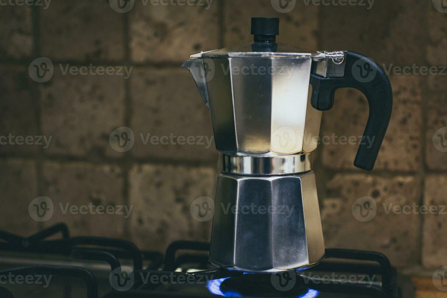 Italian traditional moka pot coffee maker on a gas stove photo