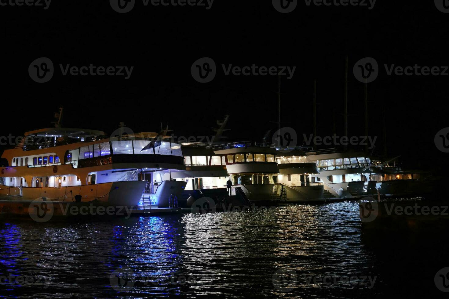 Raft of cruise ships in night harbor of  Korcula photo