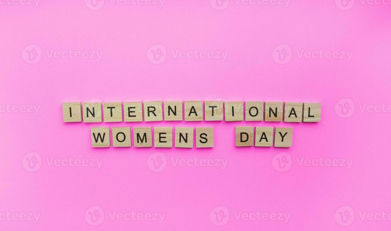 On March 8, International Womens Day, a minimalistic banner with an inscription in wooden letters photo