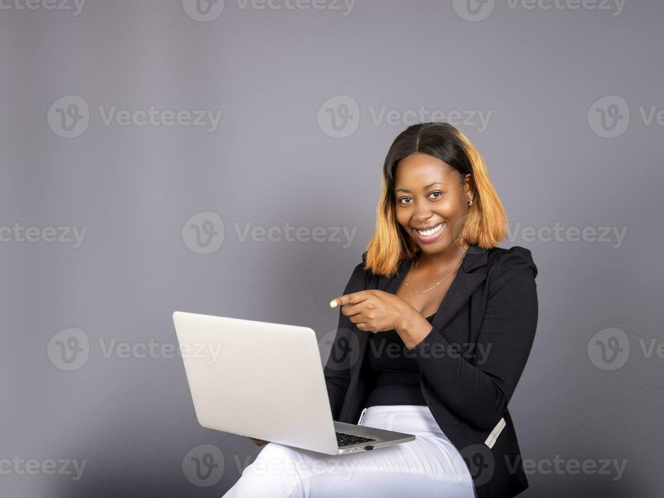 beautiful African lady using her laptop photo