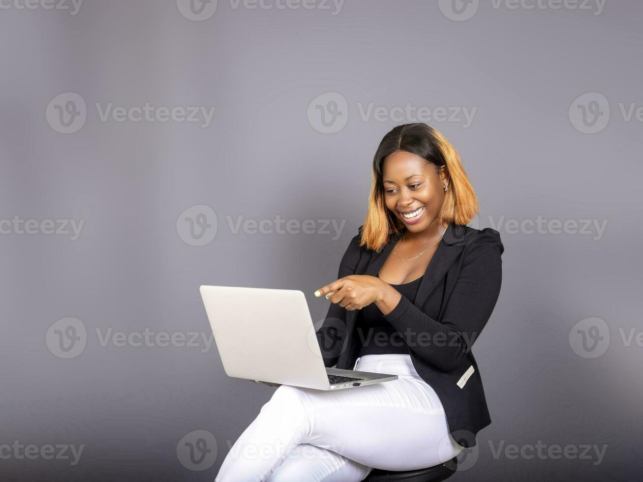 beautiful African lady using her laptop photo