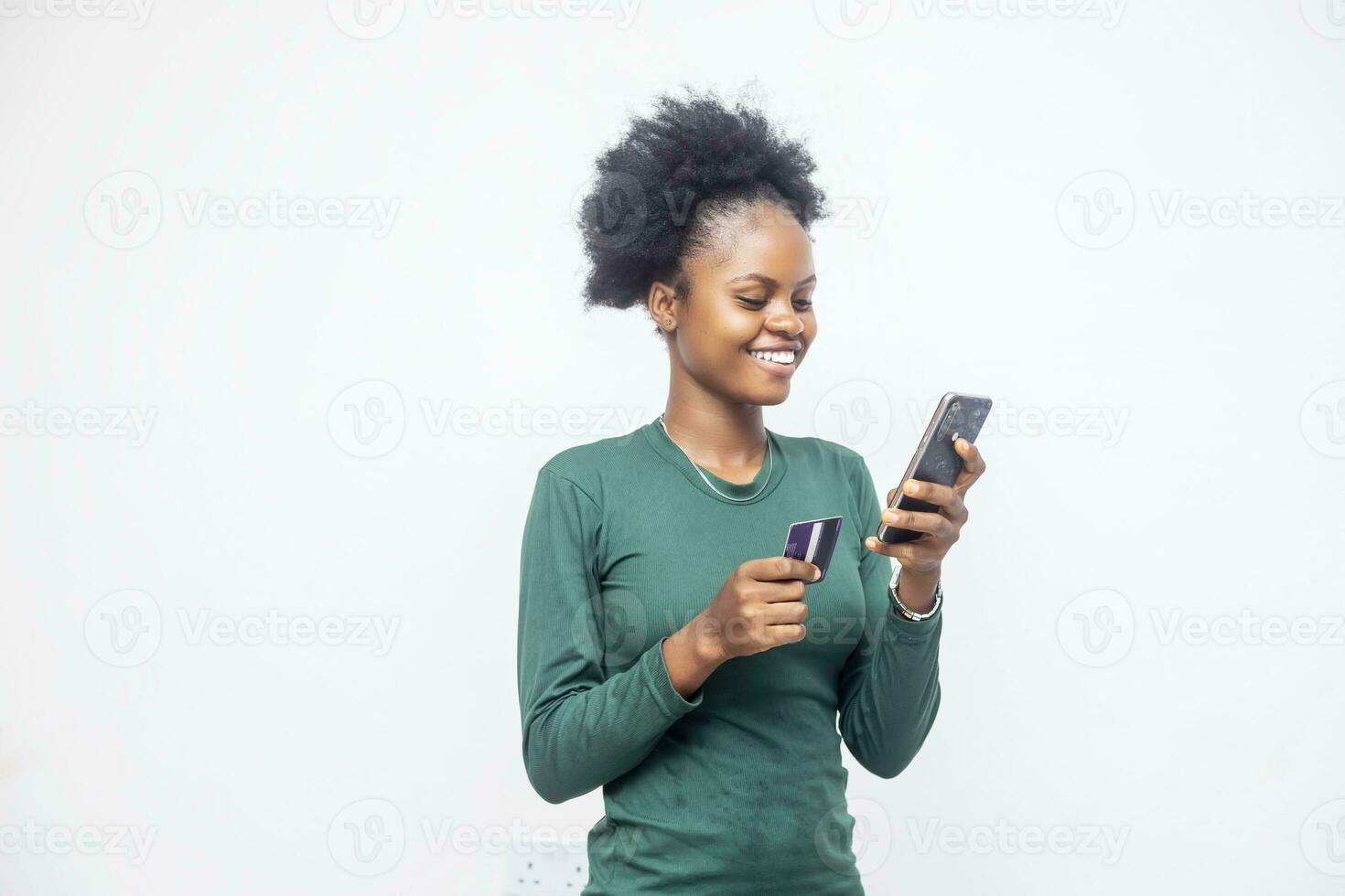 beautiful African lady using her phone and card photo