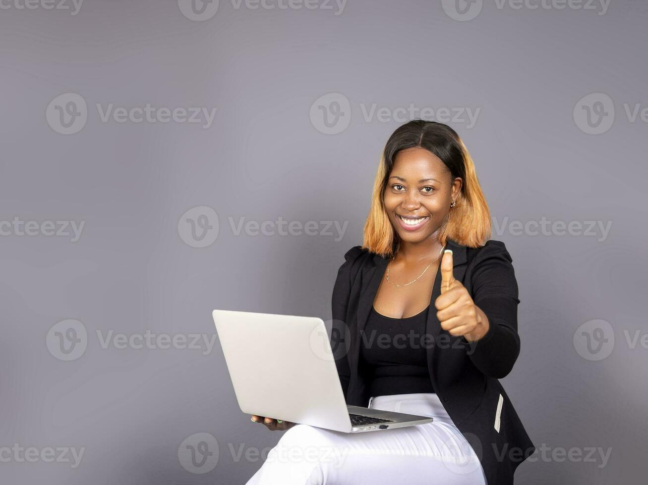 beautiful African lady using her laptop photo