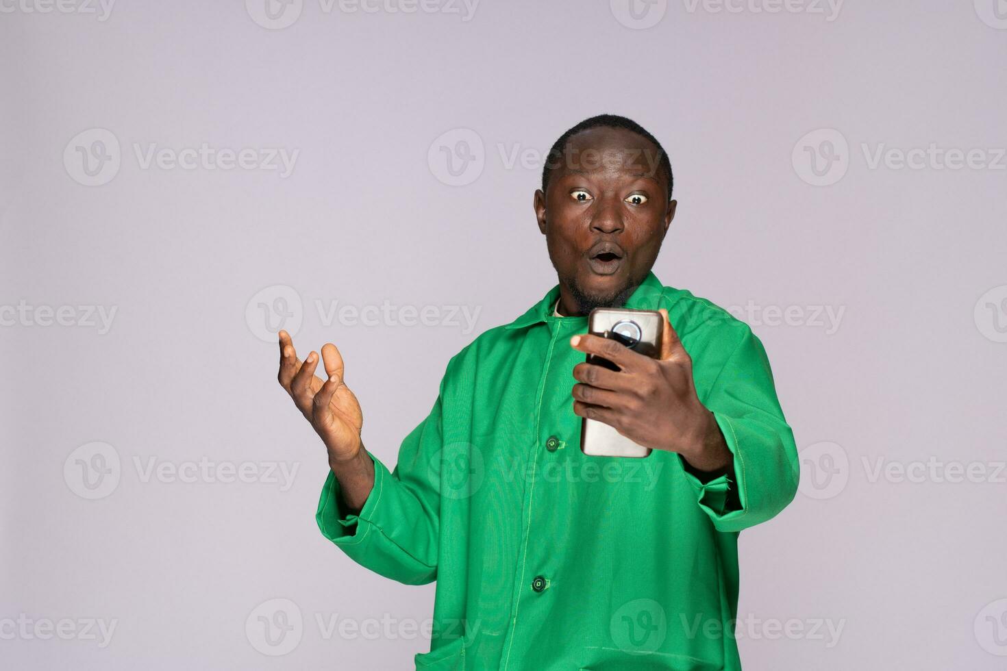 excited African man using his phone photo