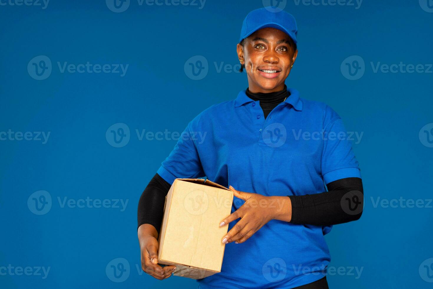 pretty african delivery worker holding a box photo