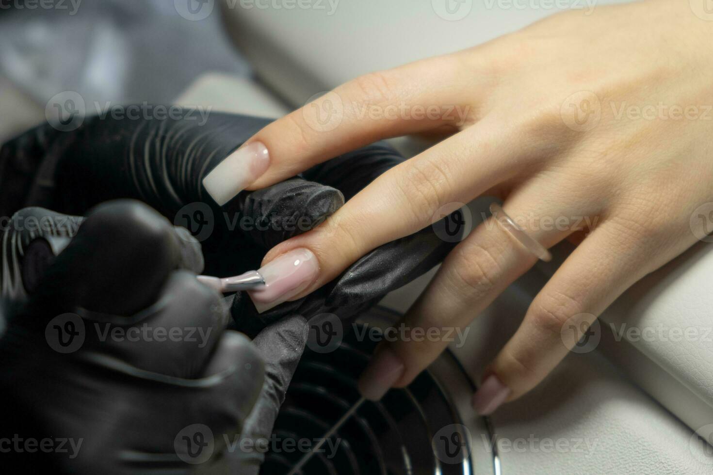Female hands and tools for manicure, process of performing manicure photo