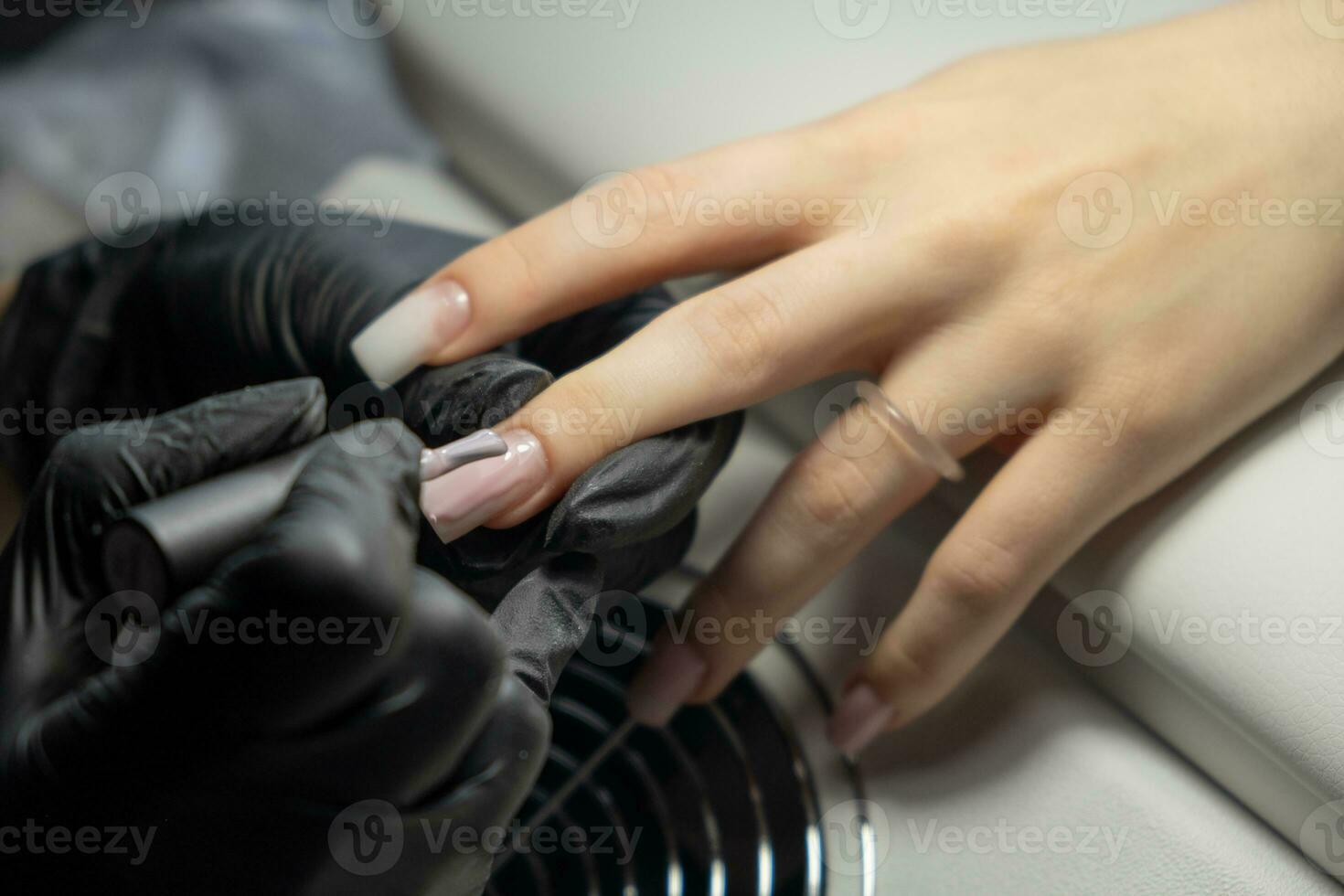 Female hands and tools for manicure, process of performing manicure photo
