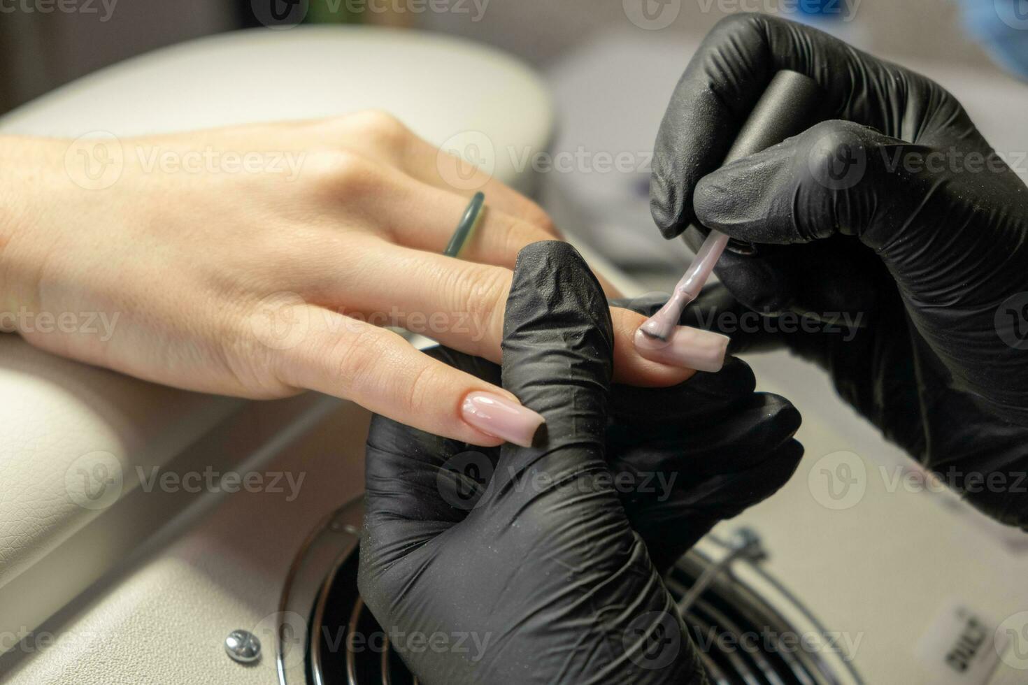 Female hands and tools for manicure, process of performing manicure photo