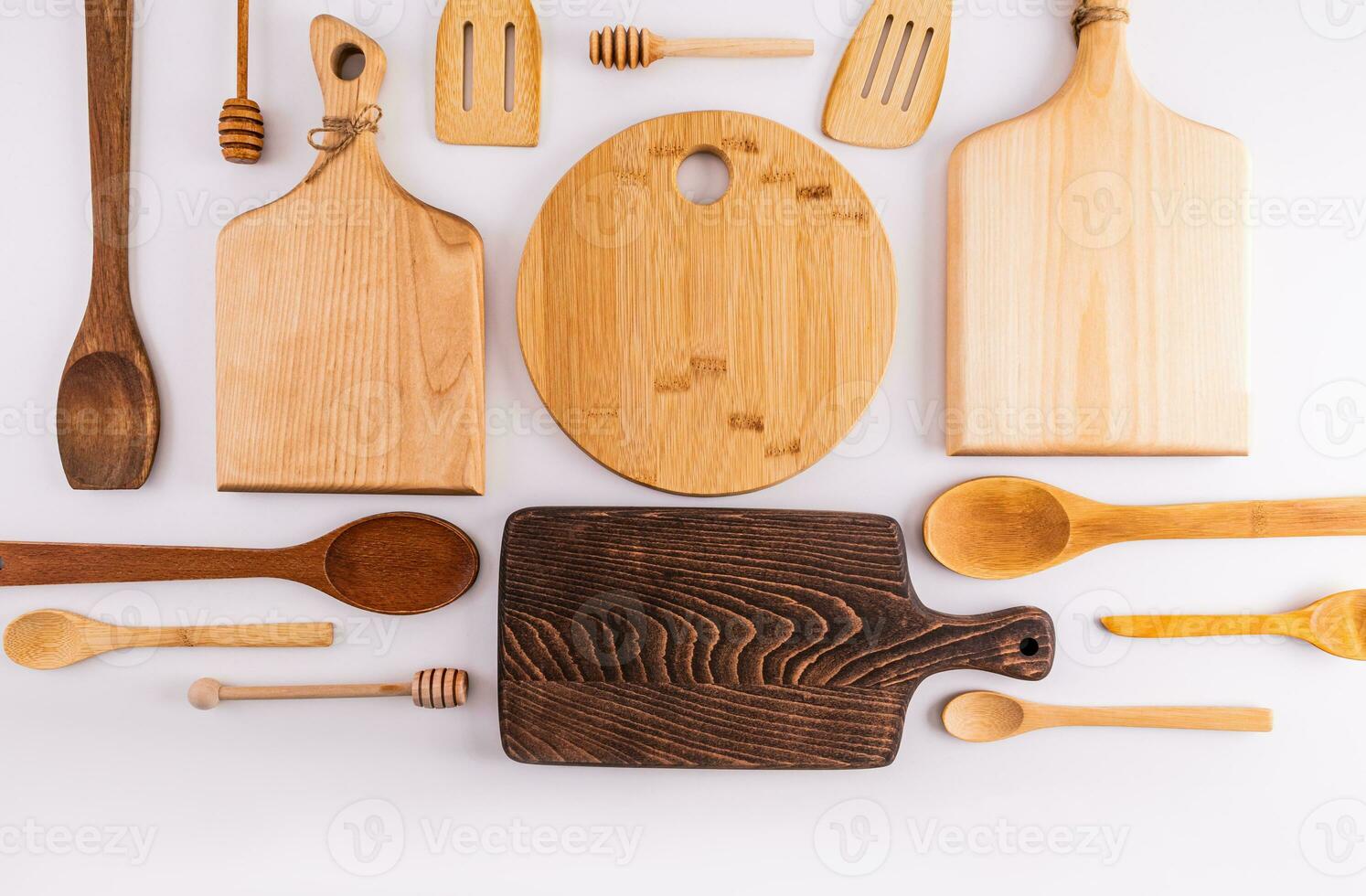 Beautiful kitchen background with wooden tool on a white table with a various cutting board in the center. Flat lay. Top view. space for text. photo
