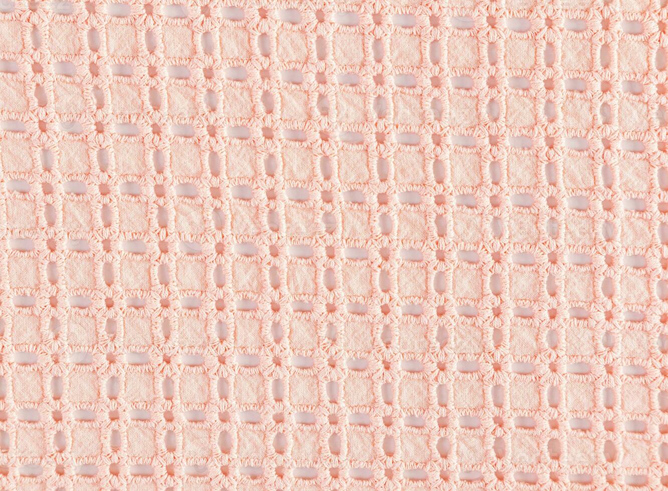 Beautiful lace cotton fabric in peach color. Layout for design. Abstract cotton texture background. The color of the year is peach fuzz. photo