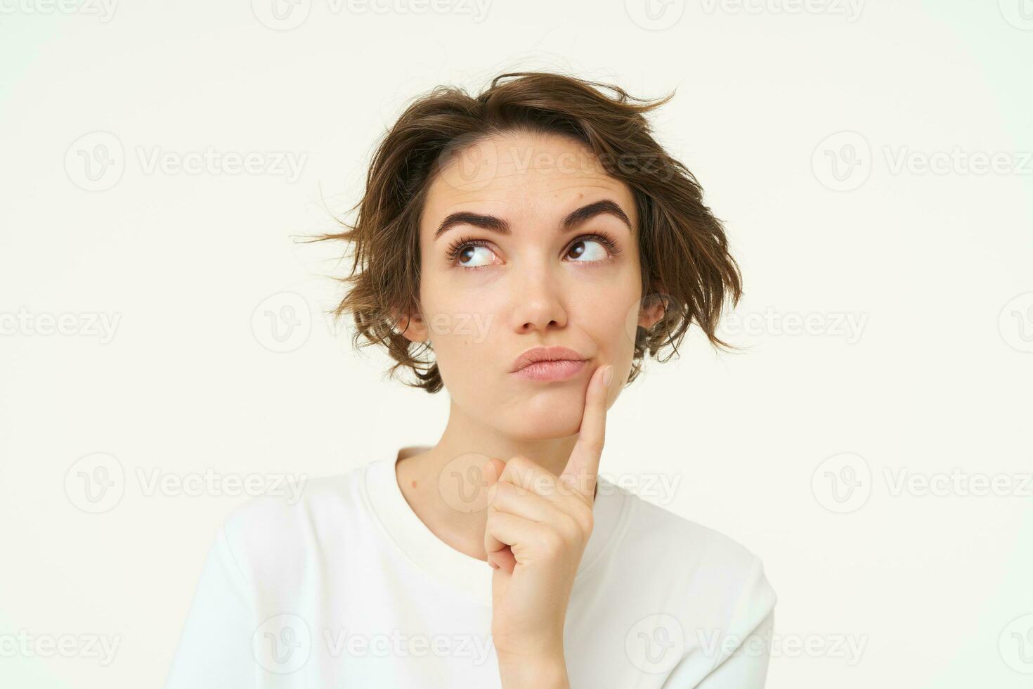 Close up portrait of woman with thoughtful face, thinking of solution, pondering, making choice, standing over white studio background photo