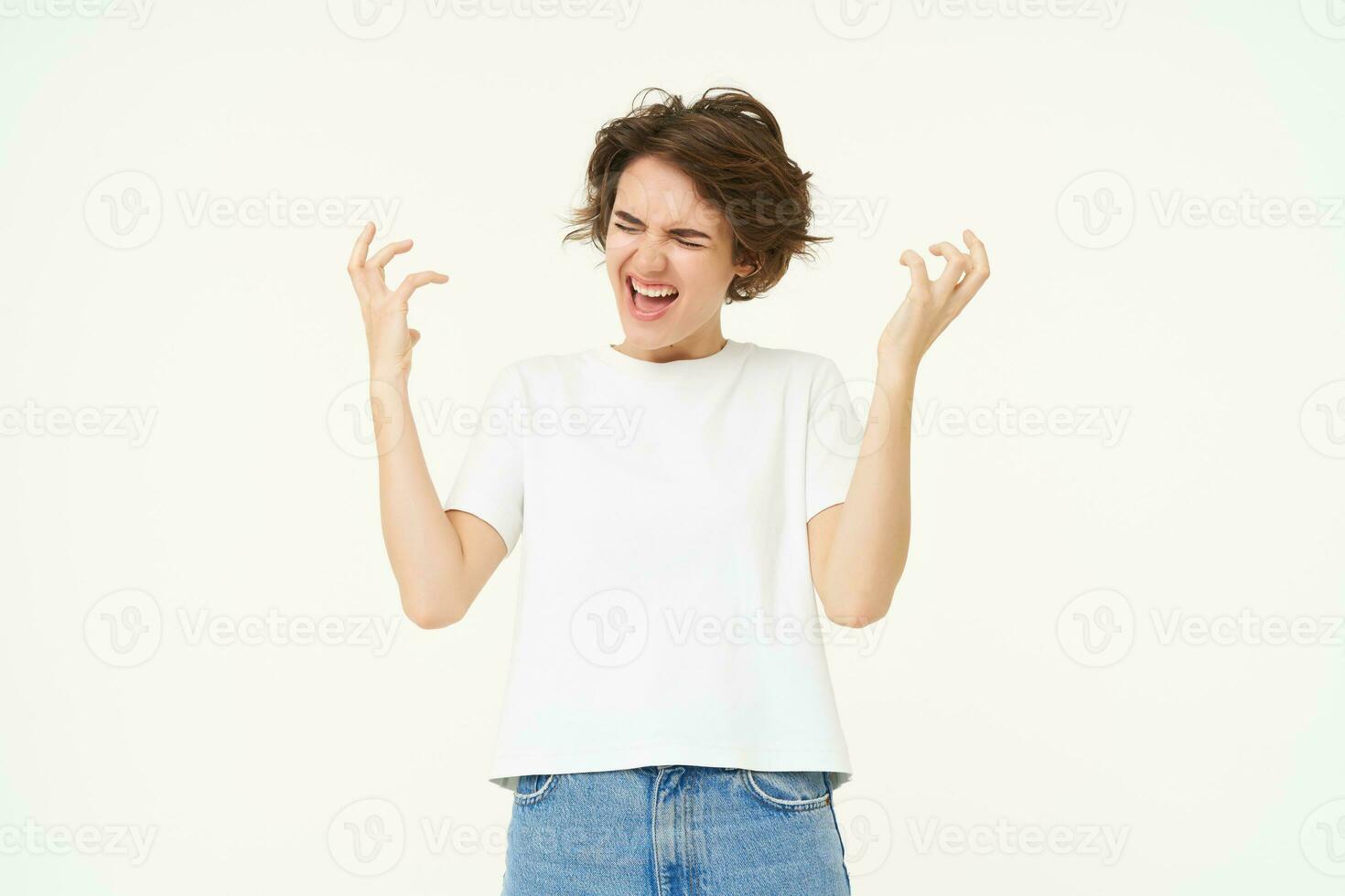 Portrait of woman celebrating, winning prize, triumphing, standing over white studio background photo