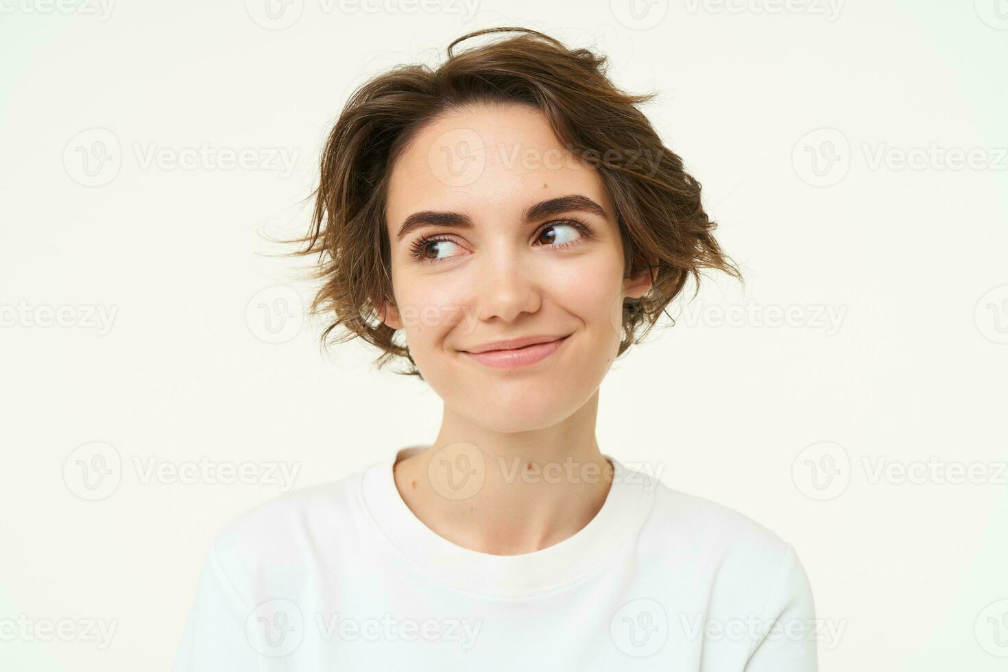 Close up portrait of brunette woman laughing and smiling, express genuine emotions, posing against white studio background photo