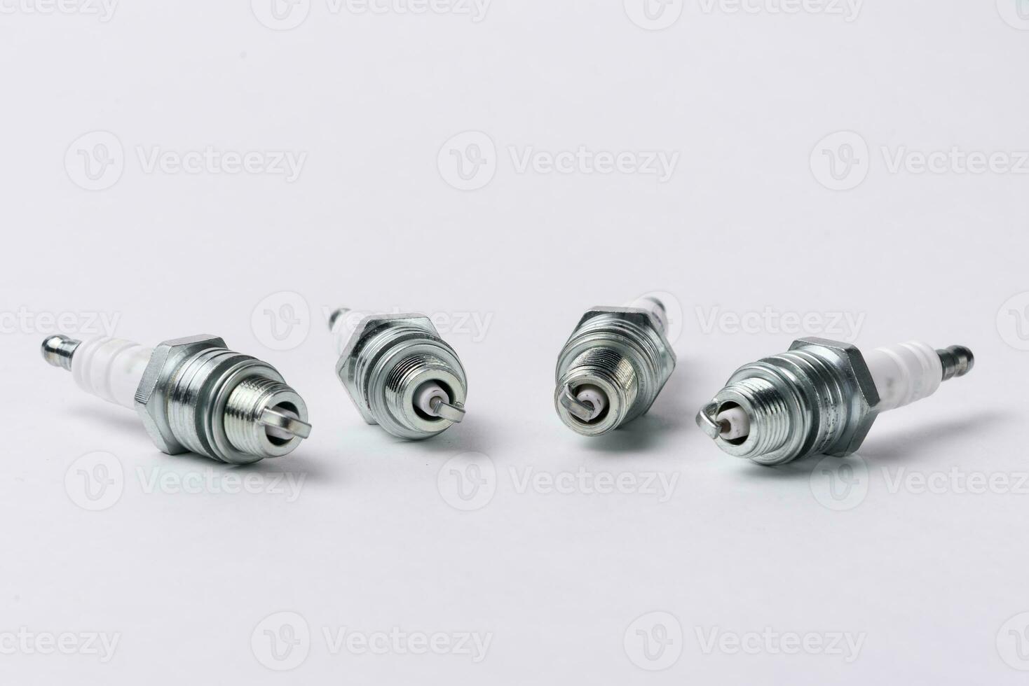 Car spark plugs on white background. Car spare parts. photo