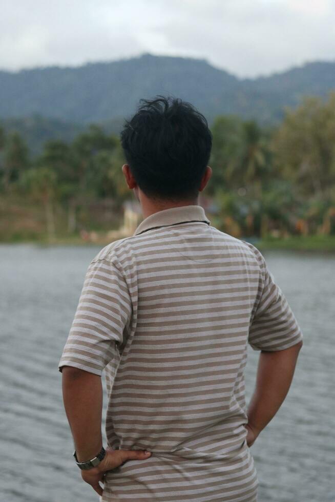 Lake Perintis, Suwawa. Sunny day scenery. Tourists admiring view on popular tourist attraction on Gorontalo, August 27, 2023 photo