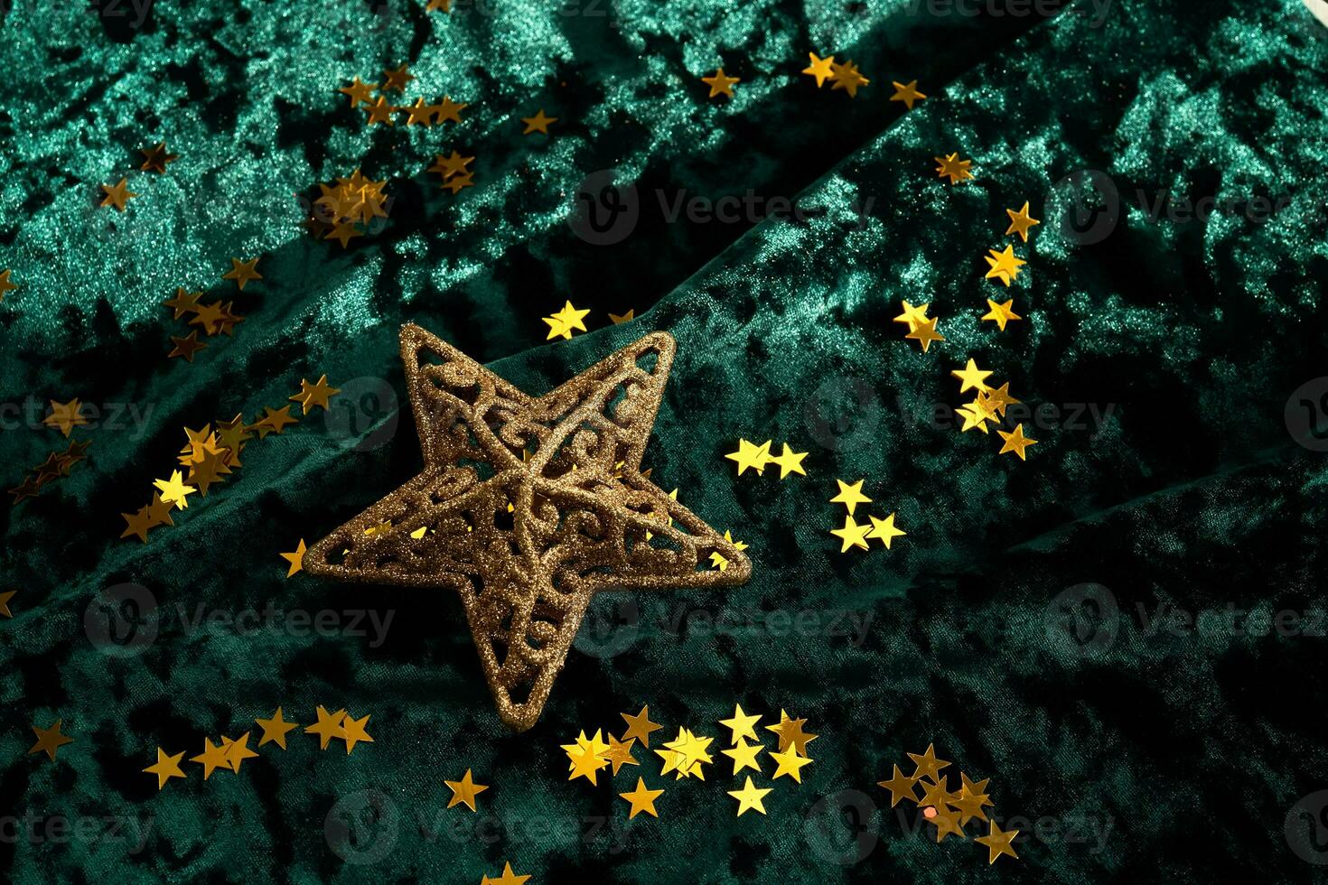 Abstract Christmas background with gold stars on a green velvet background. photo