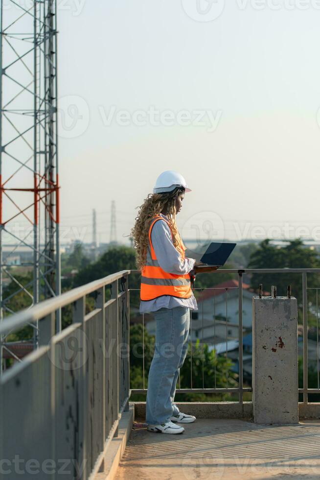 Engineer working on a building site The telephone and internet network signal systems of the construction building are being inspected. photo