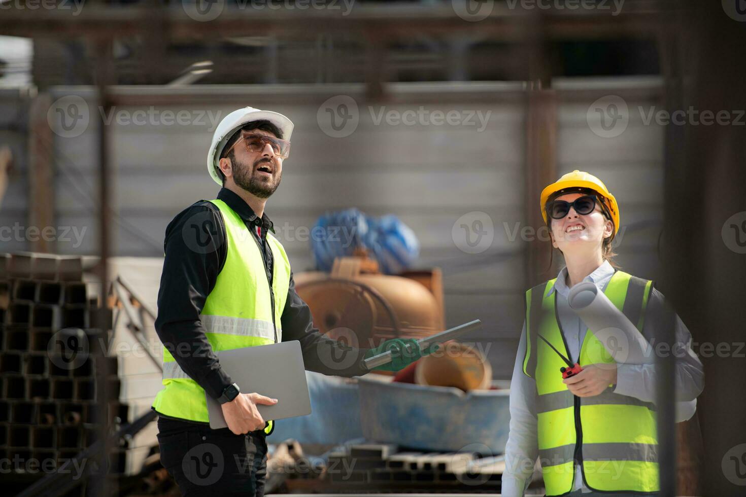 Engineer and architect working on the construction site, double-checking plans and process. photo