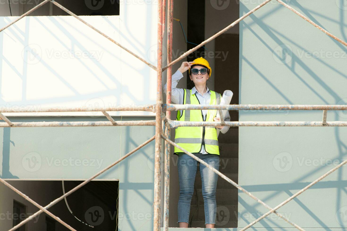 Engineer or architect working on the construction site, double-checking plans and process. photo